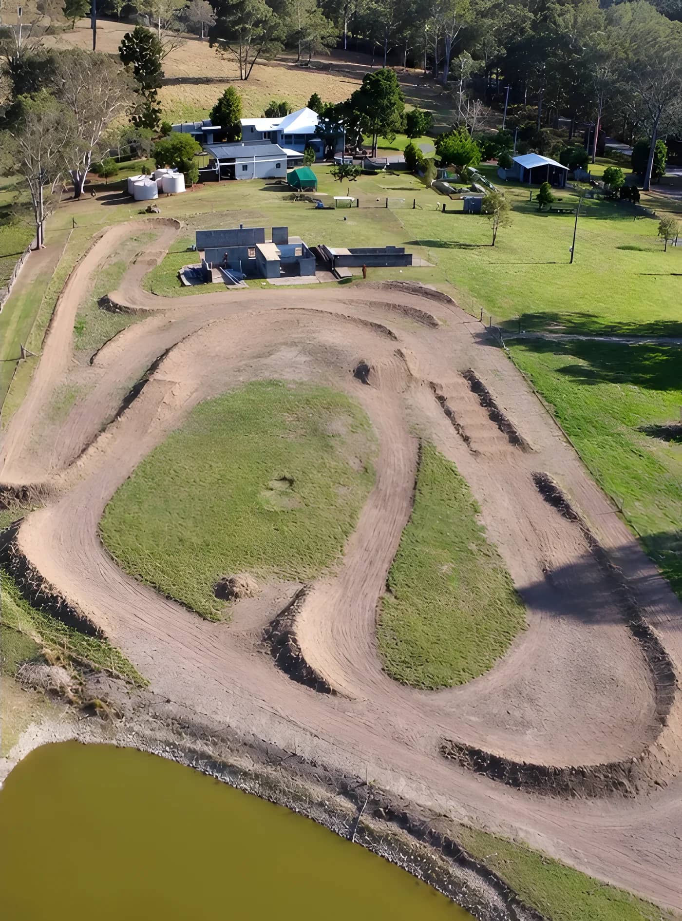 Aerial view of the dirt push-bike track beside the dam